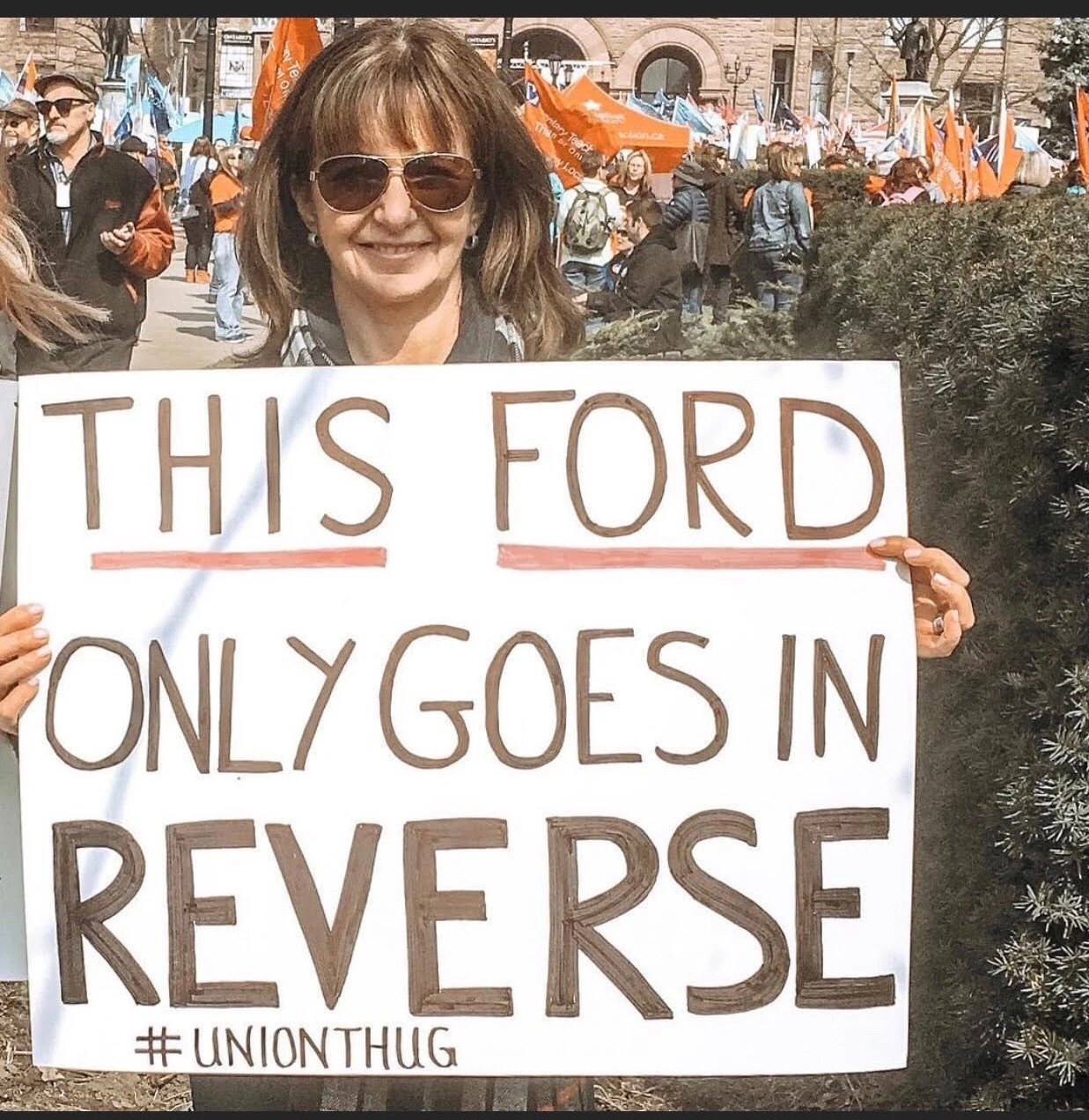 Patricia Robinson at a protest holding a sign